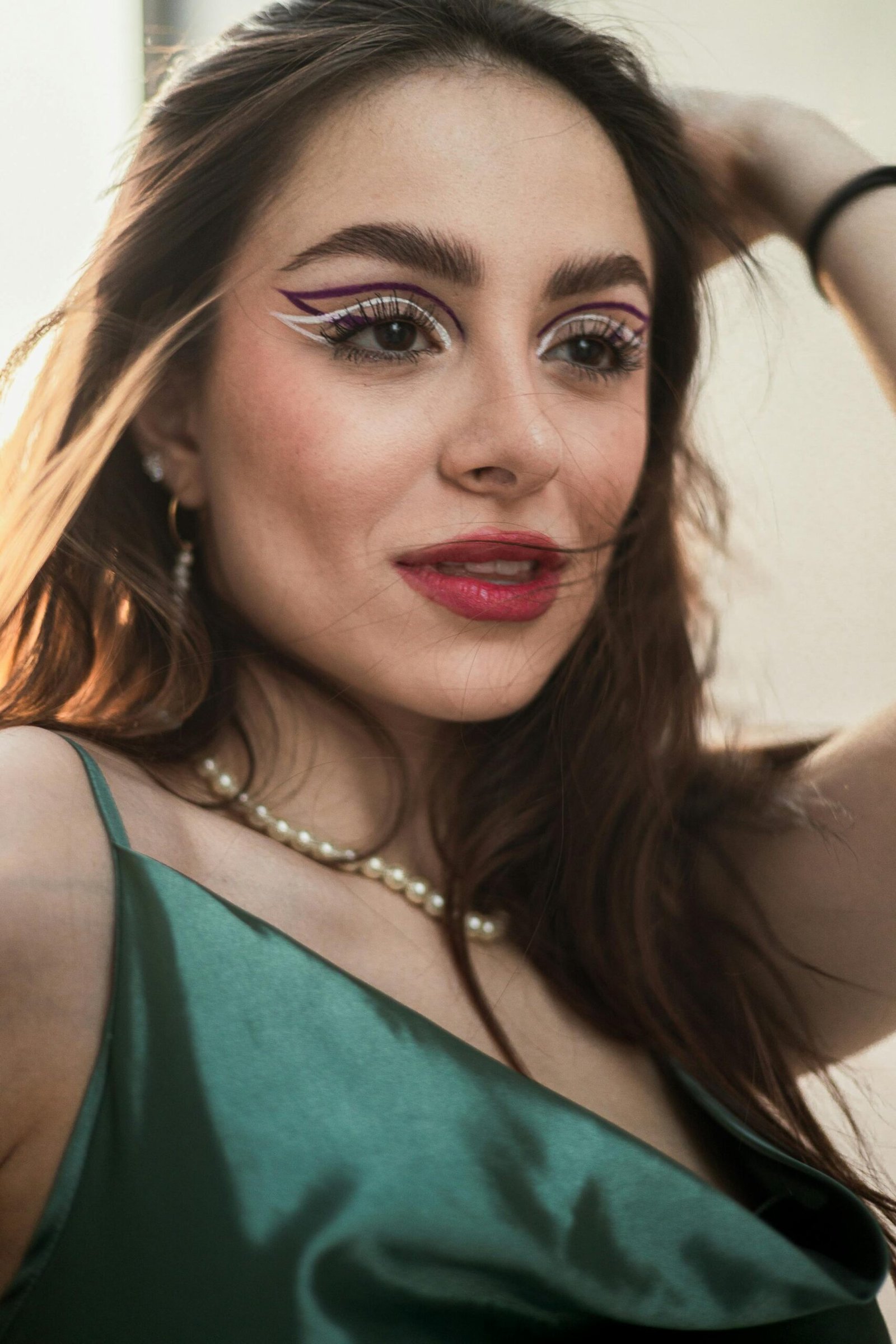 Stylish portrait of a young woman with artistic makeup and elegant fashion.
